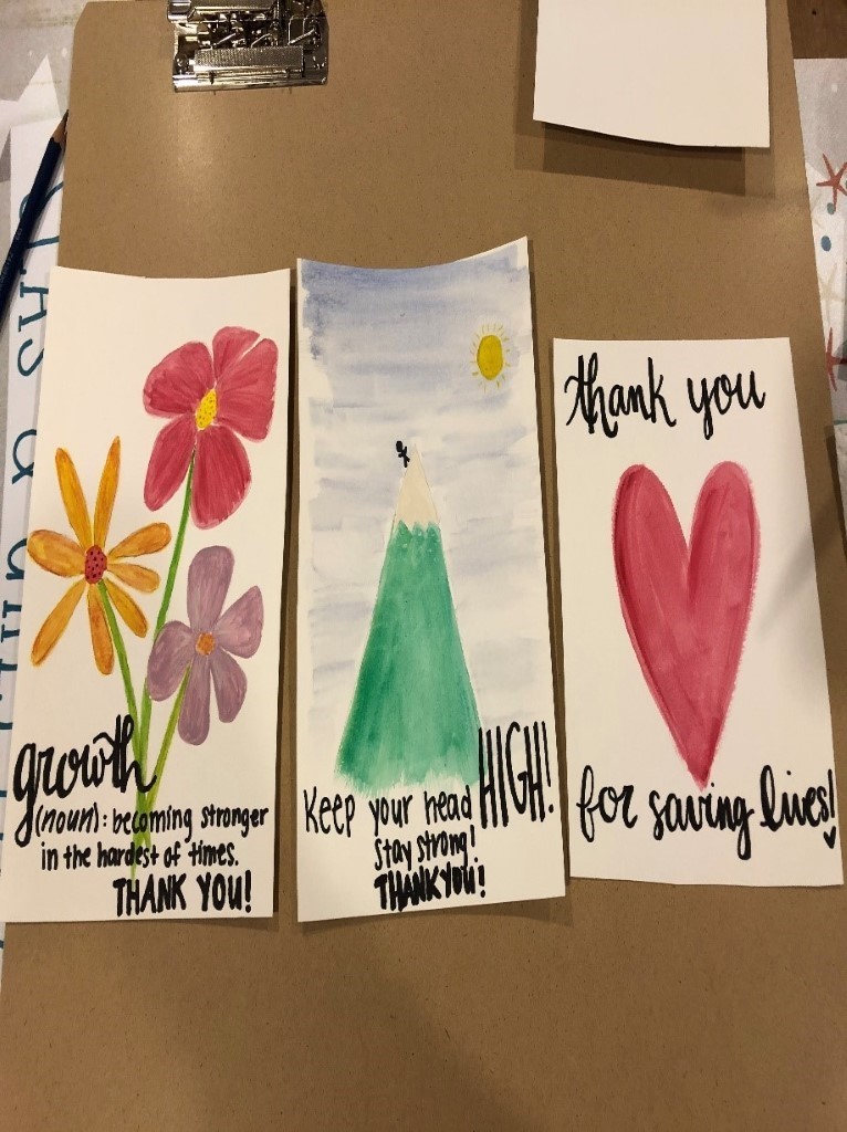 Volunteer Lindsay and Little Sister Maxine painted pictures for medical workers on the front lines and mailed them to the hospital. The final results included an outer space-themed picture by Maxine with the words "You are out of this world amazing."