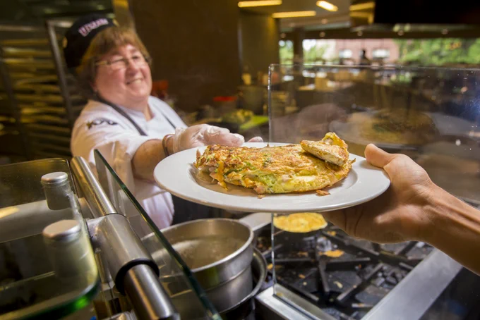 Joanne Keller serves a student a fresh omelet from the stove in Hampshire Dining Common.