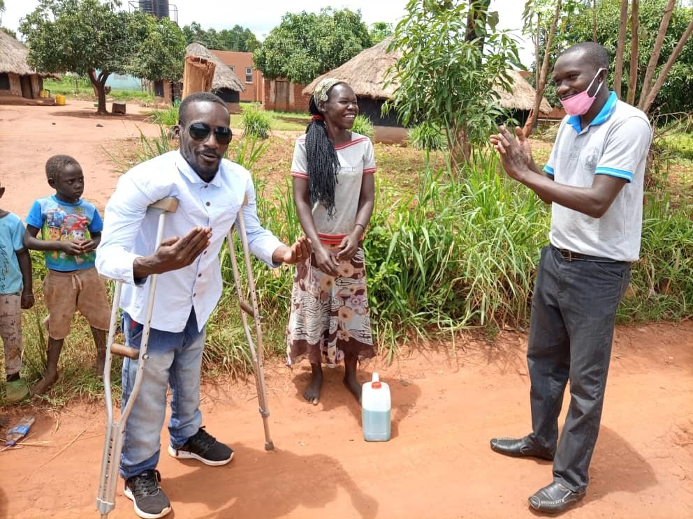 AdvocacyProject's tweet photo. Help Freeman to make and sell liquid soap in Uganda! Freeman, seen left, is training Ugandans with limited mobility to make Clean Wash soap in response to the COVID-19 crisis. https://t.co/2DdZWoO8m6