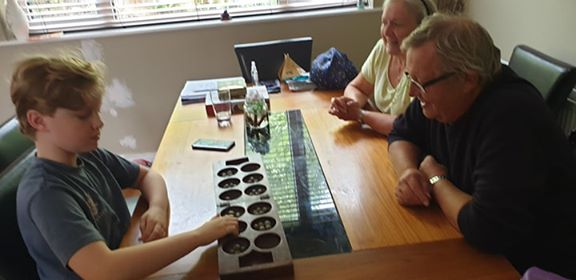 1stHelsby's tweet photo. One of our Cubs completing TGI stage one badge by playing a game of Oware, a traditional game from Ghana #TheGreatIndoors #HomeScouting https://t.co/w1aKZMBXKB