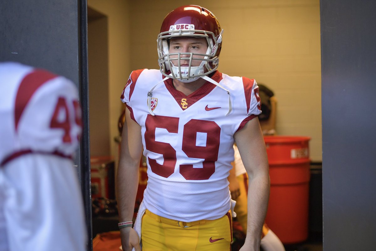 USC Football long snapper Damon Johnson exciting the locker room