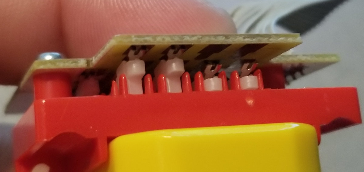 Close up of the module while a block is in there.You can see how some pins have been pushed up by the block, while the two on the right haven't. So the switch turns "on" when there's no hole, and "off" when there is a hole.