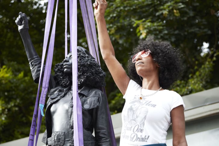 CNN's tweet photo. A sculpture of a Black Lives Matter protester has replaced a slave trader statue in the UK.

The work is officially titled "A Surge of Power (Jen Reid) 2020" and depicts a woman with her fist raised in a Black Power salute. https://t.co/Qx42f7ntNK https://t.co/aOVVCzxdmH