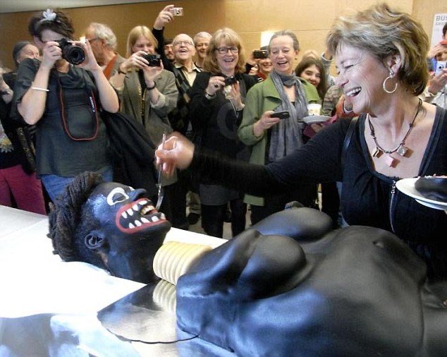 Furthermore, below is Swedish minister Lena Adelsohn Liljeroth. The cake was designed as a racist caricature of an African woman, supposedly to depict the harmful/inhumane process of FGM. They told her to whisper "your life will be better after this" as she cuts into the crotch.