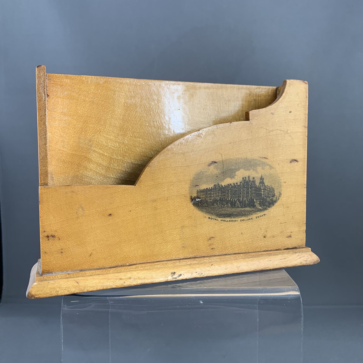 Next up: It’s a letter holder, featuring print of Royal Holloway, University of London on right hand corner. Date of manufacture unknown.But is it a part of our collection?