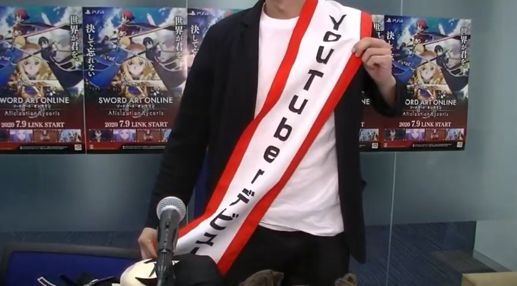 The stream began with Futami flaunting his "Youtuber debut" sash... only problem is that Futami failed to make his stream actually work on Youtube at first, so he had to run back to Periscope instead... so, Futami took it off till next week.
