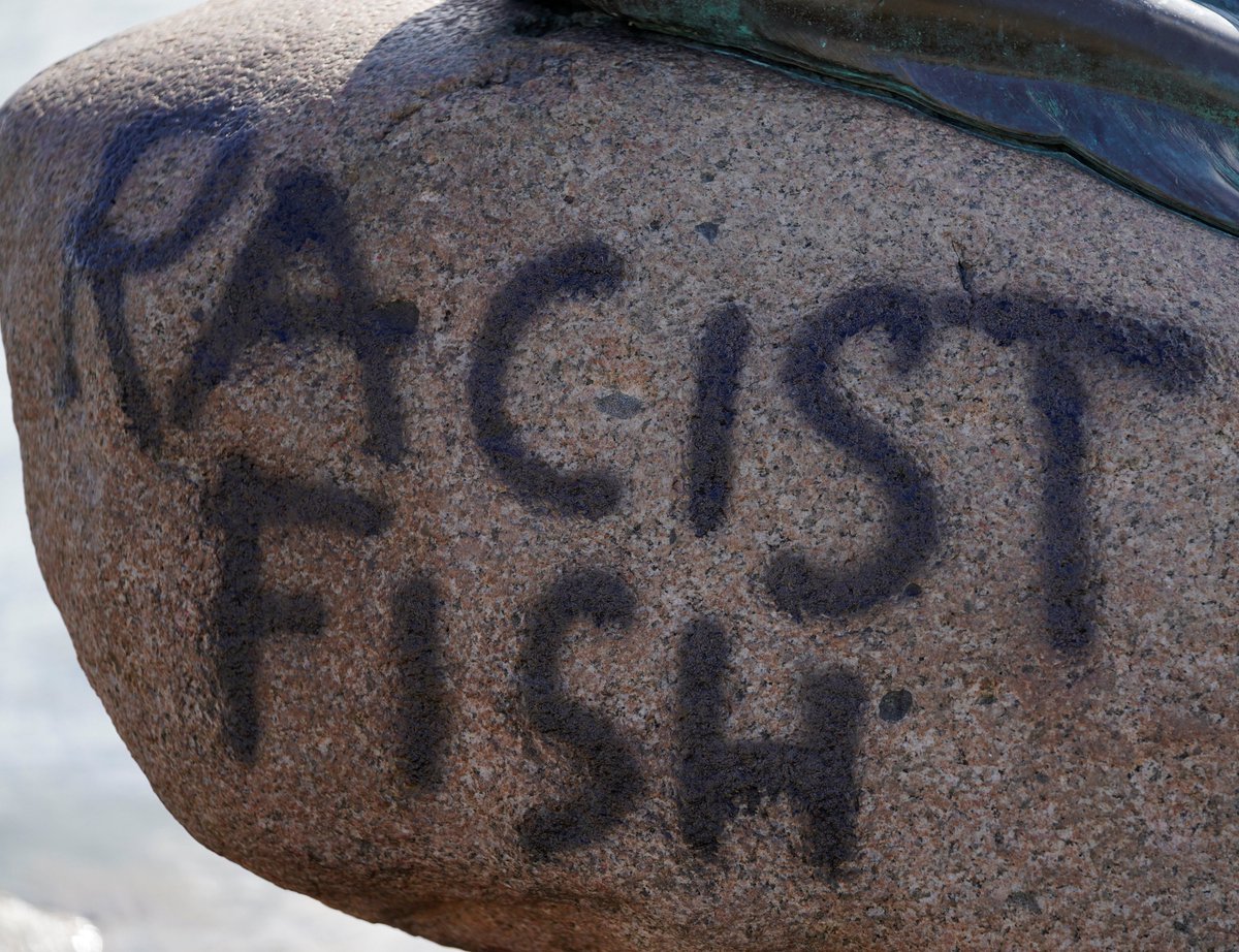 ajplus's tweet photo. Denmark's Little Mermaid statue has been graffitied with the words "Racist Fish".

Researchers and police say it isn't clear why the statue was targeted, but it has been graffitied by activists before, and decapitated twice. https://t.co/DDbN6qtleK