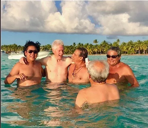 26) The men in the photo are Ricardo Cheaz, Bill Clinton, George Nader, José Calzada, and Rolando Gonzalez Bunster. https://truepundit.com/busted-muellers-new-star-witness-trump-caught-partying-exclusive-island-resort-bill-clinton/