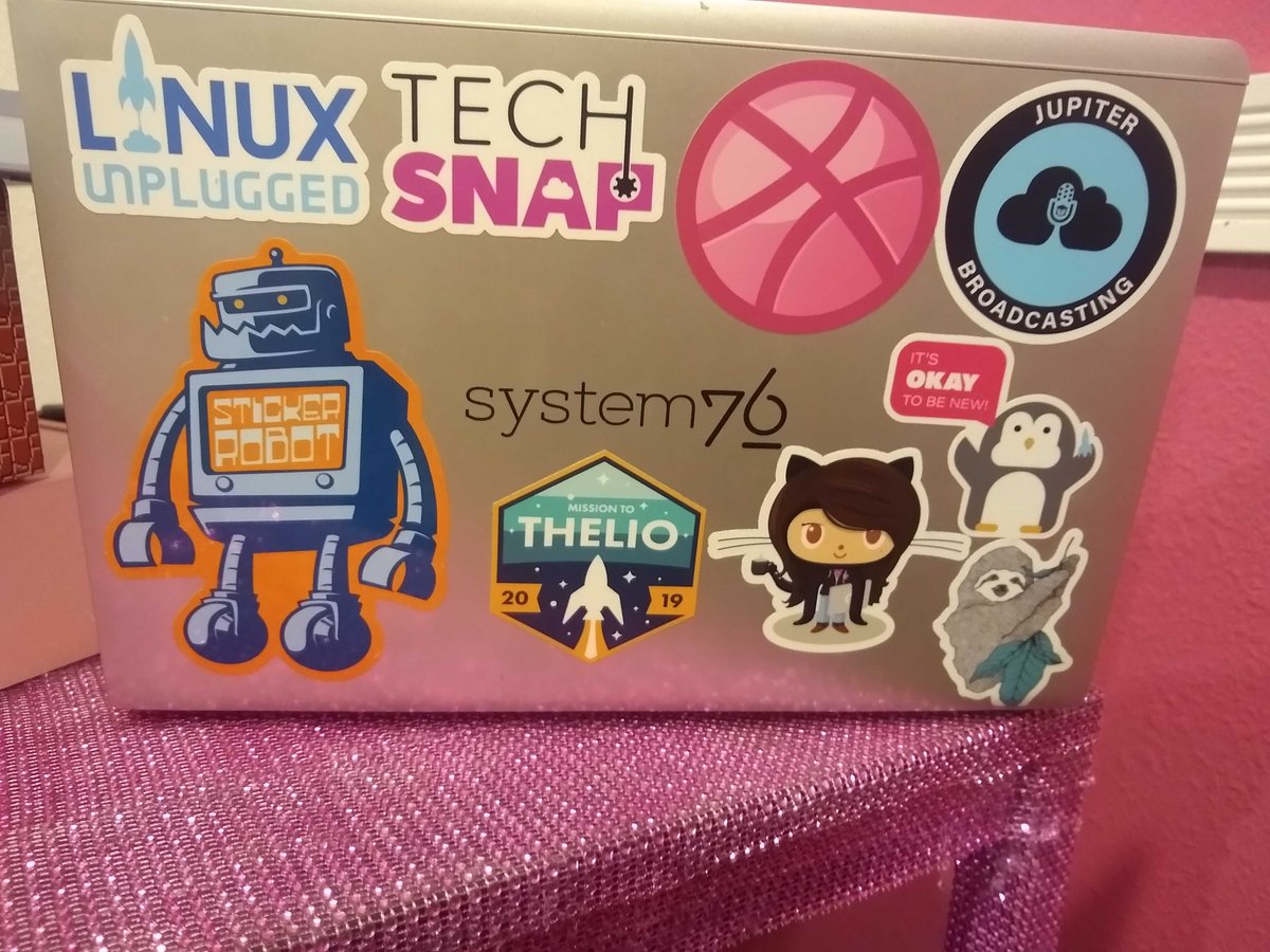 system76's tweet photo. @SocialHappiness Emmaโs #geekflag flies with pink flair! Show us how you fly yours by posting a picture of your laptop stickers using #geekflag! https://t.co/fhgaX2jNdk