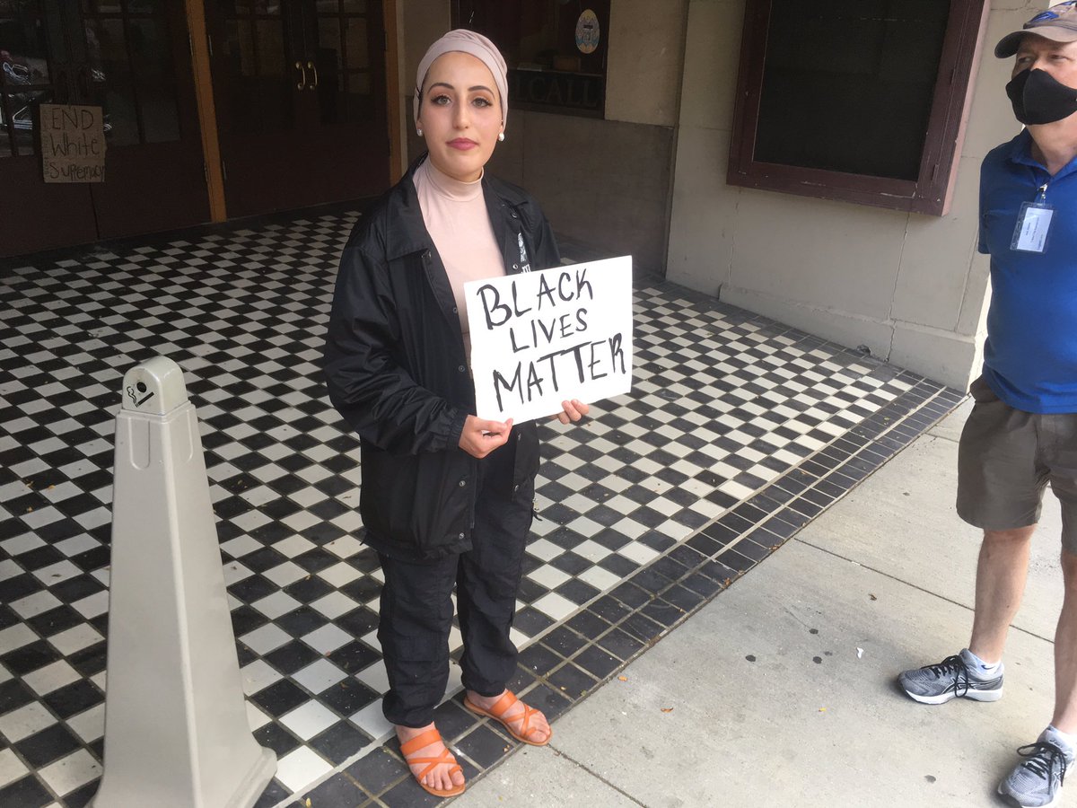 Afnan Beauti, a student who lives here in downtown Marion, is standing in front of the Lincoln Theatre, holding a "Black Lives Matter" sign. She says a lot of people have told her "All lives matter," and some have been Rider, cussing or flicking her off.