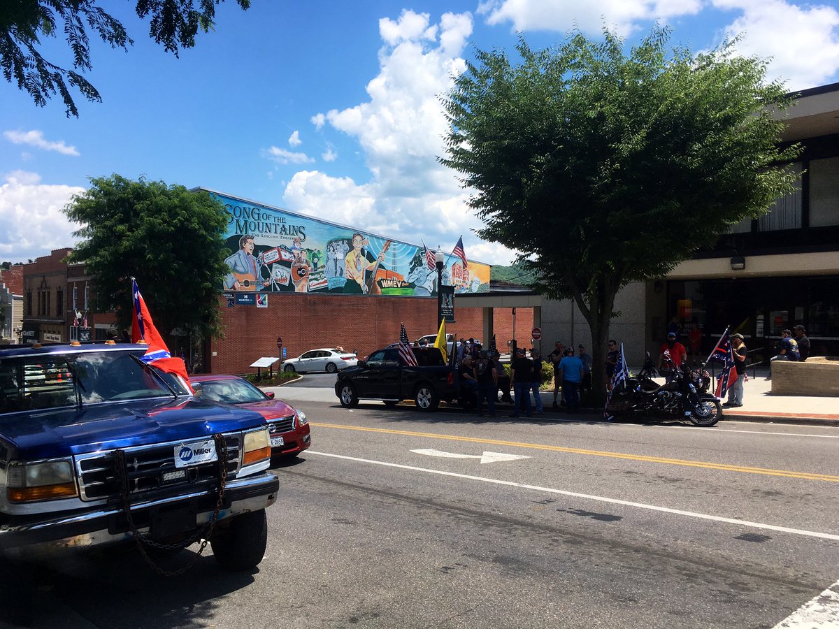 Gatherings on the street beneath the Lincoln Theatre's Song of the Mountains mural
