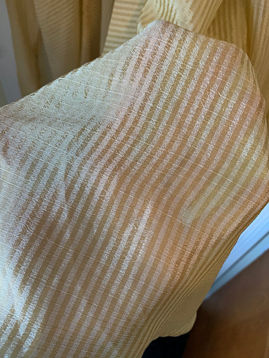 The fabric is very shiny and sheer and soft. Each side has a single snap + hook and eye closure to fasten in the back