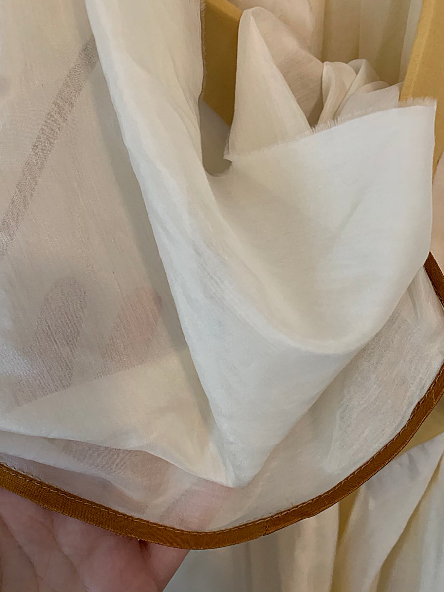 A single snap with a hook and eye on the collar. It& #39;s got structure but it& #39;s... really soft? I think it& #39;s got padding inside. The neckline was completed with this random long piece of fabric because of course it was.