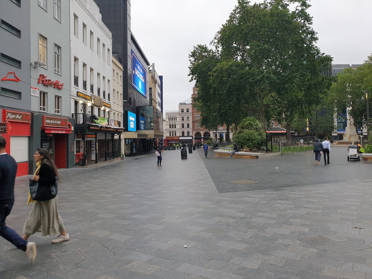 St Martin's Lane is dead. Banners for Madame Butterly and Rusalka flutter redundantly above the ENO while three sit on the steps outside.