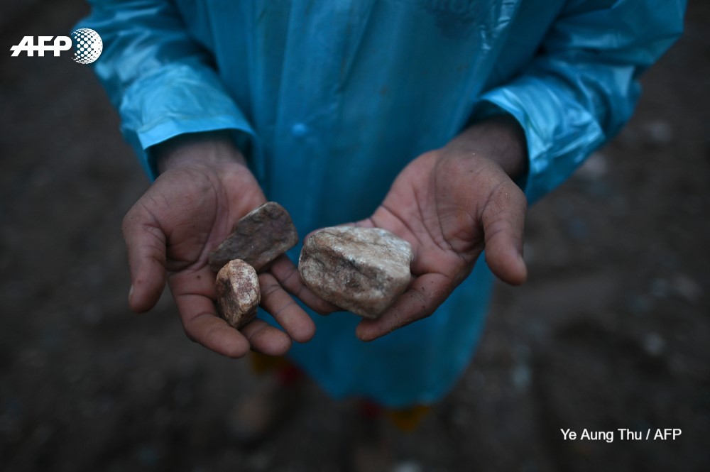 Miners work in open-cast jade mines near Hpakant in Myanmar's Kachin