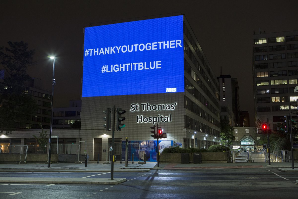 An image of a blue light projected onto St Thomas' Hospital with white writing that says "#THANKYOUTOGETHER" and "#LIGHTITBLUE"