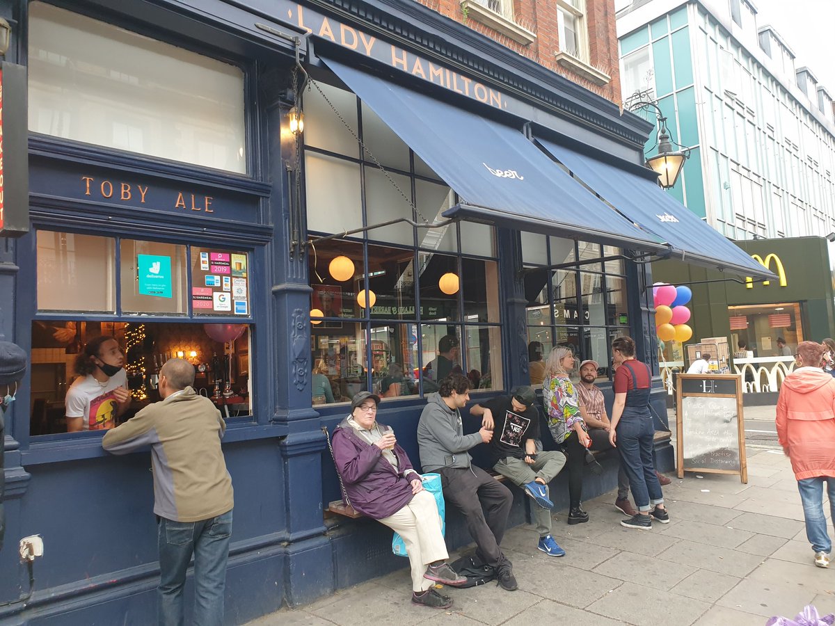 Few drinkers outside the Lady Hamilton in Kentish Town Road. (This is a request stop only, inform the driver if you wish to alight)