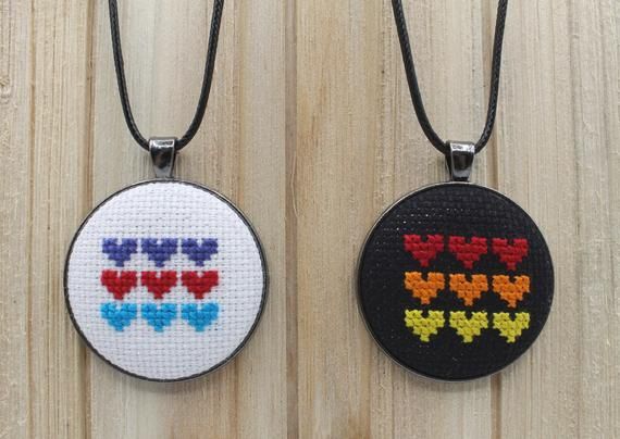 There's just something about several small hearts in a row that make these cross stitch pendants feel big. A simple, subtle addition to any outfit with a pop of color. etsy.me/2Zz5fvj #crossstitchjewelry #minicrossstitch