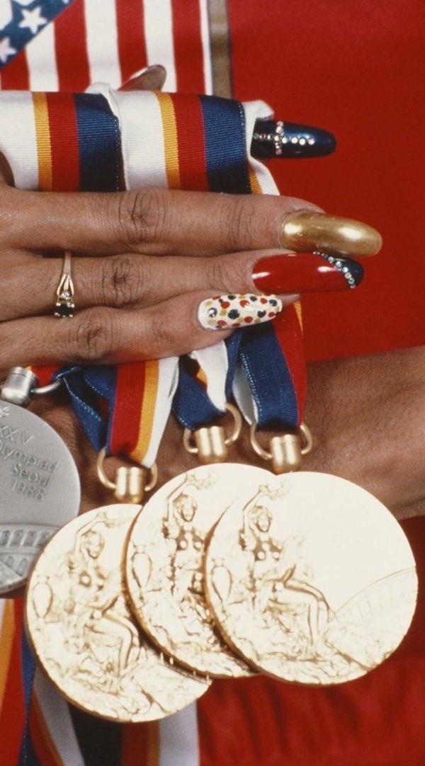 There are a few figures who helped push nail culture forward, but some were exposed to racist and classist perceptions of acrylics. One of those women was Florence Griffith Joyner, an Olympic athlete whose world records still stand.