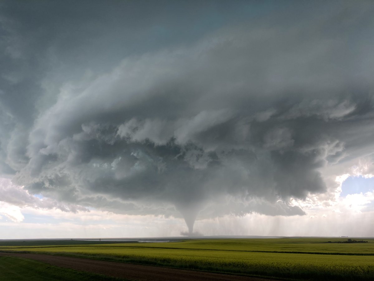 JustinBouvier's tweet photo. Tornado north of Meyrone Sk! Lots of hail but not much damage. #skstorm https://t.co/DEgqsc5TNw