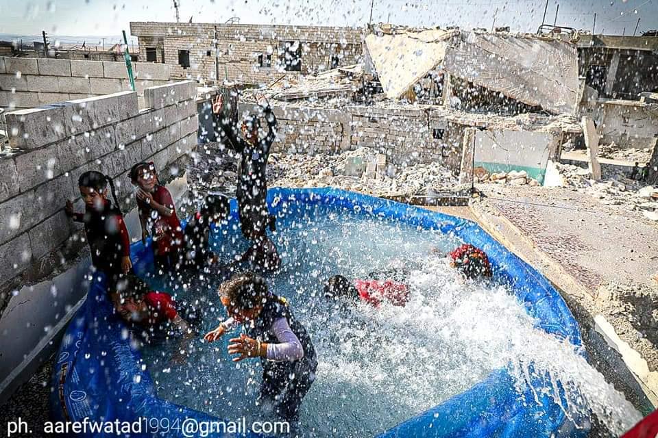 Hasanalmossa's tweet photo. Yes, A little fun with water
 Temperatures are exceeding 40 °C and the conditions in the tents are just horrible. #Idlib #Syria https://t.co/zSgPnABKoM