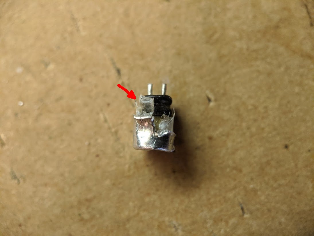 i think this capacitor has a manufacturing defect. see that plastic film that's right up next to the rubber plug? i don't think it's supposed to be there. it seems to be incomplete, it only covers part of the plug and there may have been a tiny gap