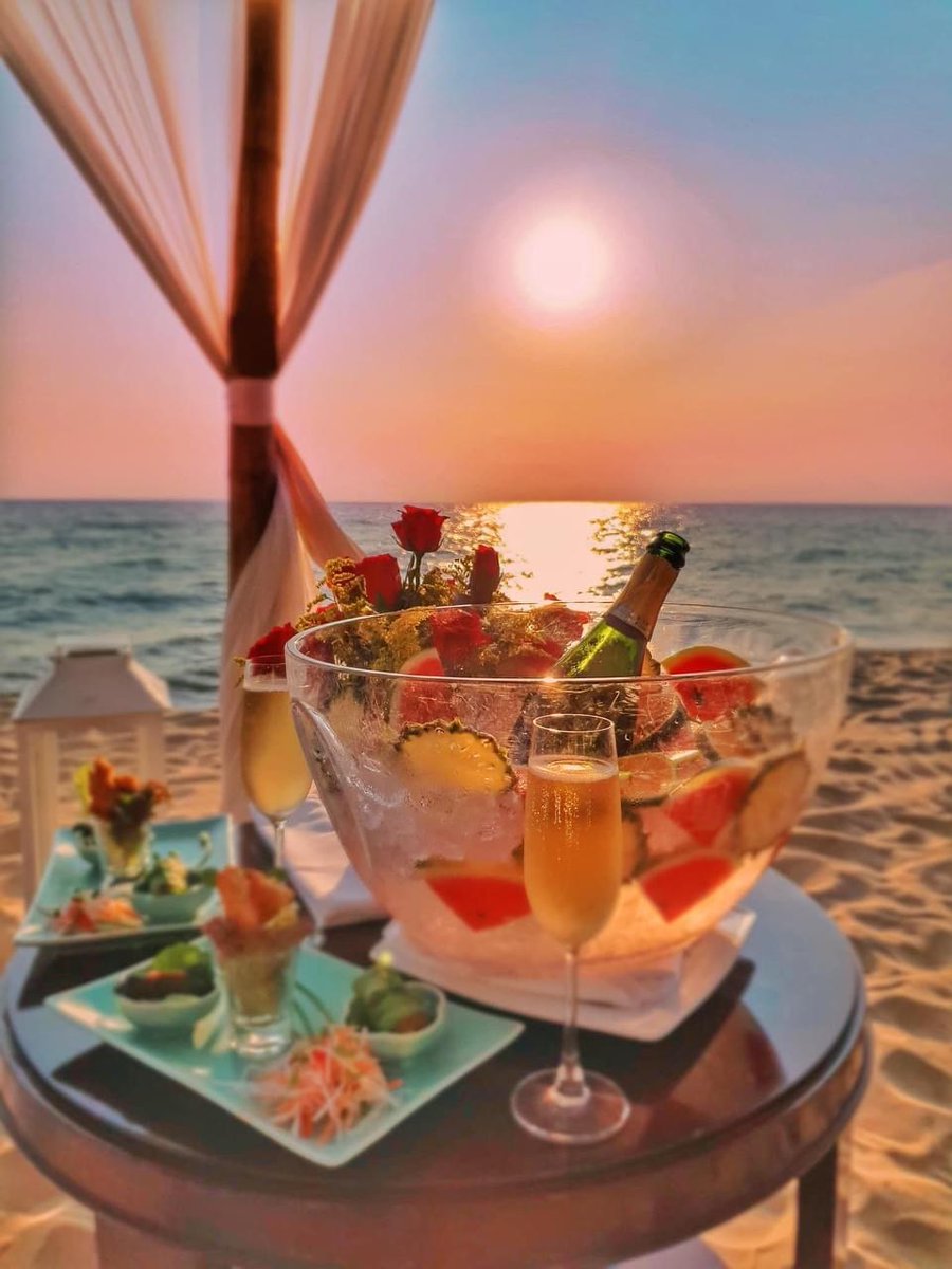 LaVerandaResort's tweet photo. The day’s last light reflects off the ocean, shimmering in the calm dusk air. Nestled together on the soft white sands, you sip fine Champagne and gaze out at the radiant gold and crimson of the dazzling twilight sky. 
Summer Offers: https://t.co/8XgbOTjY0n. https://t.co/Zkw9B8nNz7
