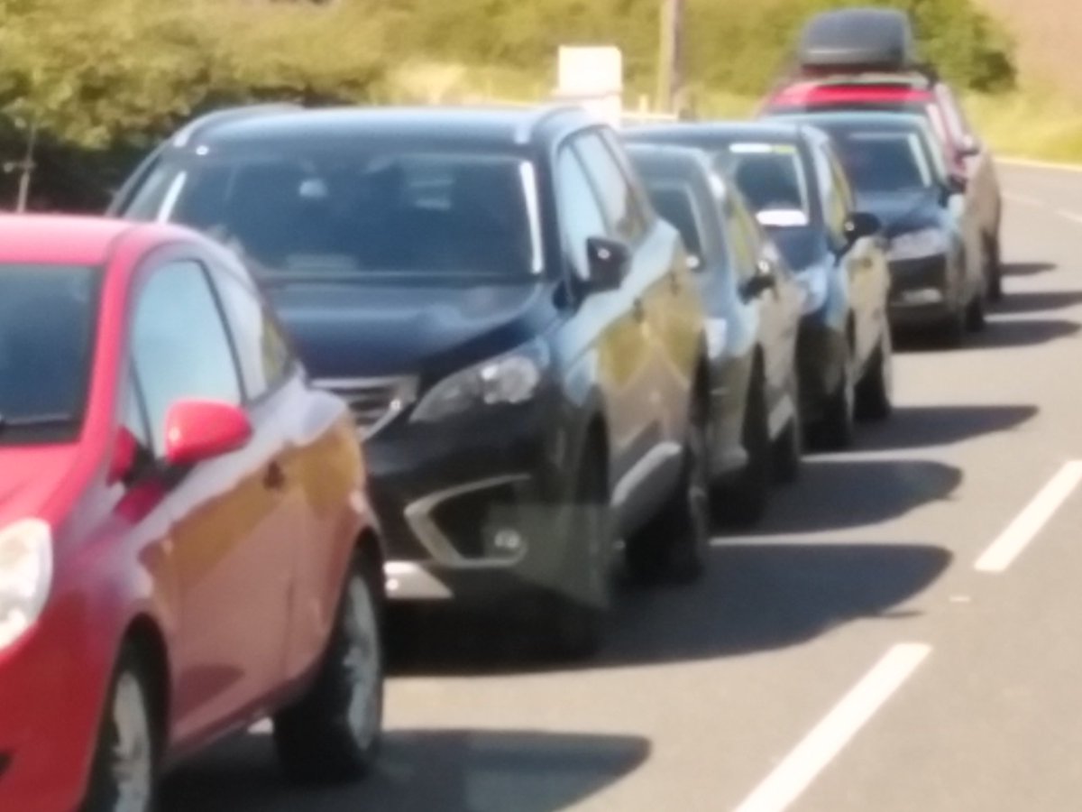 GazzGallagher's tweet photo. @deptinfra this is the road after the entrance to the Giants Causeway today, buses struggling to get by with oncoming traffic, all to avoid the official car park. Help is required. https://t.co/3I05MNA80W