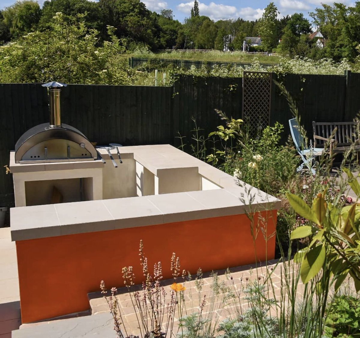 This outdoor kitchen is going to be a hub of family activities this summer! Another fabulous Conway Landscapes creation! ⭐⭐⭐⭐⭐ #outdoorkitchen #garden #entertainment #loveyourgarden #pizzaoven #pizza #BBQ #orange #landscaper