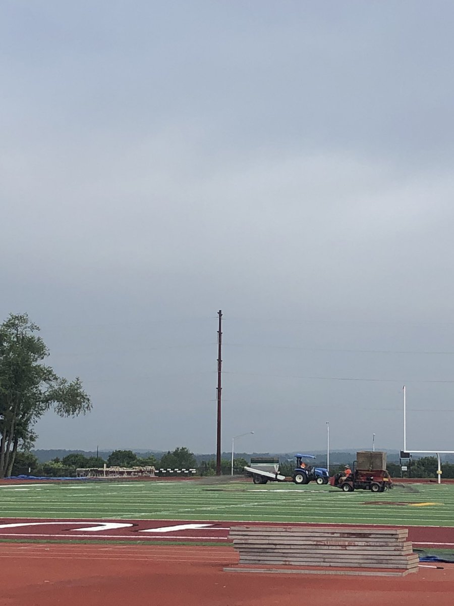 CoachHenicles's tweet photo. Finishing touches as they spread the rubber (“dirt”).  Ready for play when things start in a month 🤞. #GoHuskies #PullTogether https://t.co/QmLiQlg0xF
