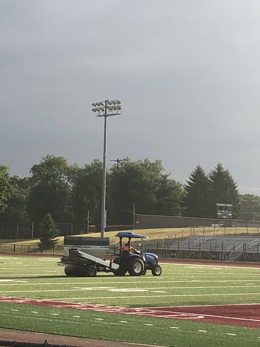 Finishing touches as they spread the rubber (“dirt”).  Ready for play when things start in a month 🤞. #GoHuskies #PullTogether