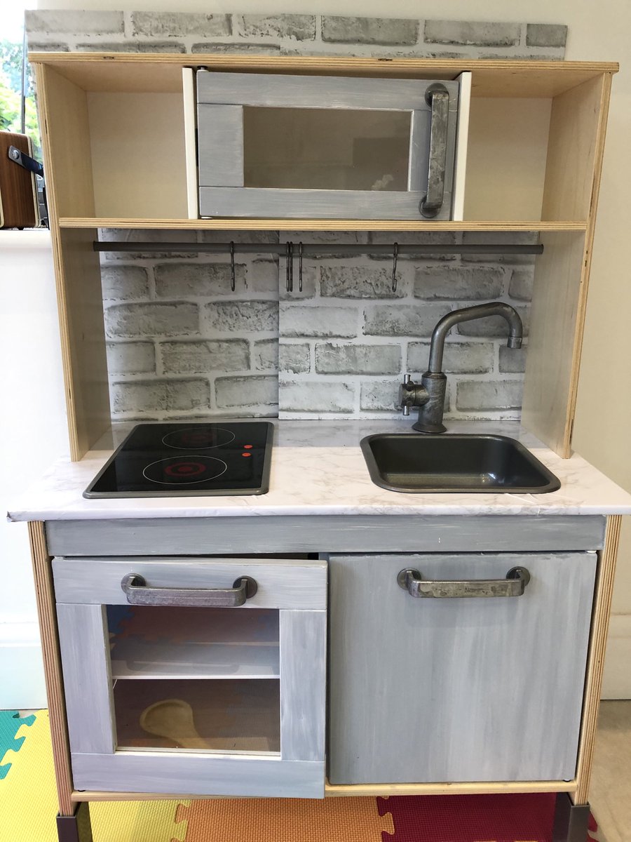 jenlipman's tweet photo. What else to do when stuck at home but renovations? The Ikea toy kitchen, now with painted grey cupboards, a fancy marble counter, aged metal taps and a brick effect splashback... #ifonlyitwasreal https://t.co/YVahkzk6ZE