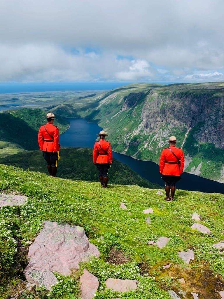 RCMPNL's tweet photo. Staying active on their days off, these Deer Lake #RCMPNL officers climbed the Gros Morne Summit while carrying something special in their pack to change into when they reached the top. Congrats on taking the Serge to new heights! #RedSergeProud #YourRCMPNL #806m #GrosMorne https://t.co/rmXPYl0LbZ