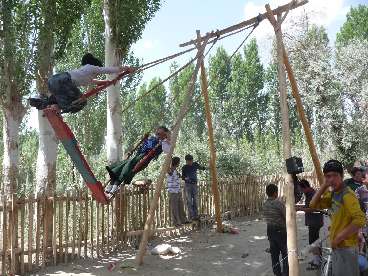 Every year in late spring, pilgrims would arrive at Imam Asim, near Khotan, in the thousands. The first stop was a special seasonal market at the edge of the desert, with children's rides, a tight rope act, and sweets for sale.
