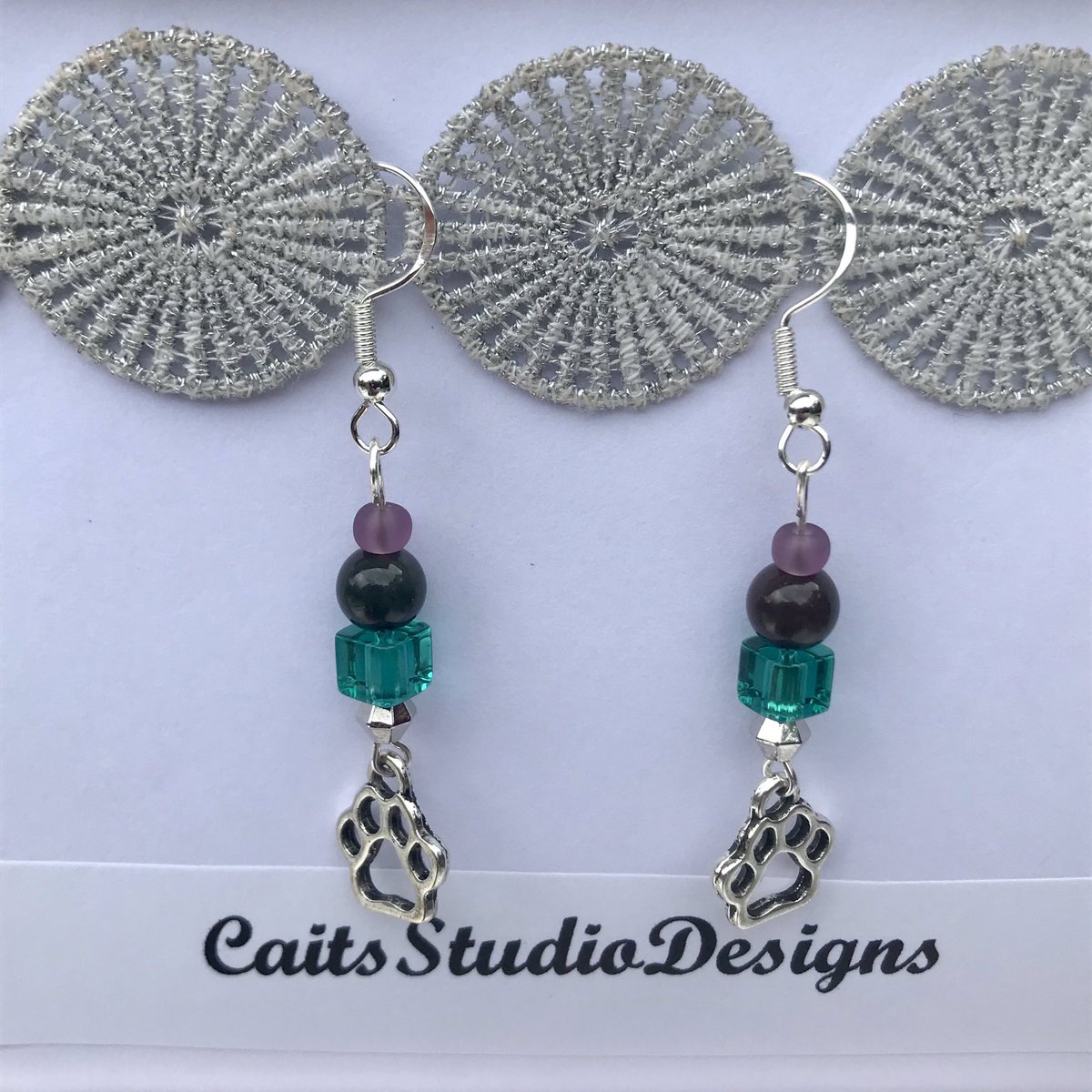 New design. What do you think?  
#beadedearrings #beadedjewelry #caitsstudiodesigns #earringsoftheday #etsyfinds #dangleearrings #dogearrings #pawprints #pawearrings #dogjewelry