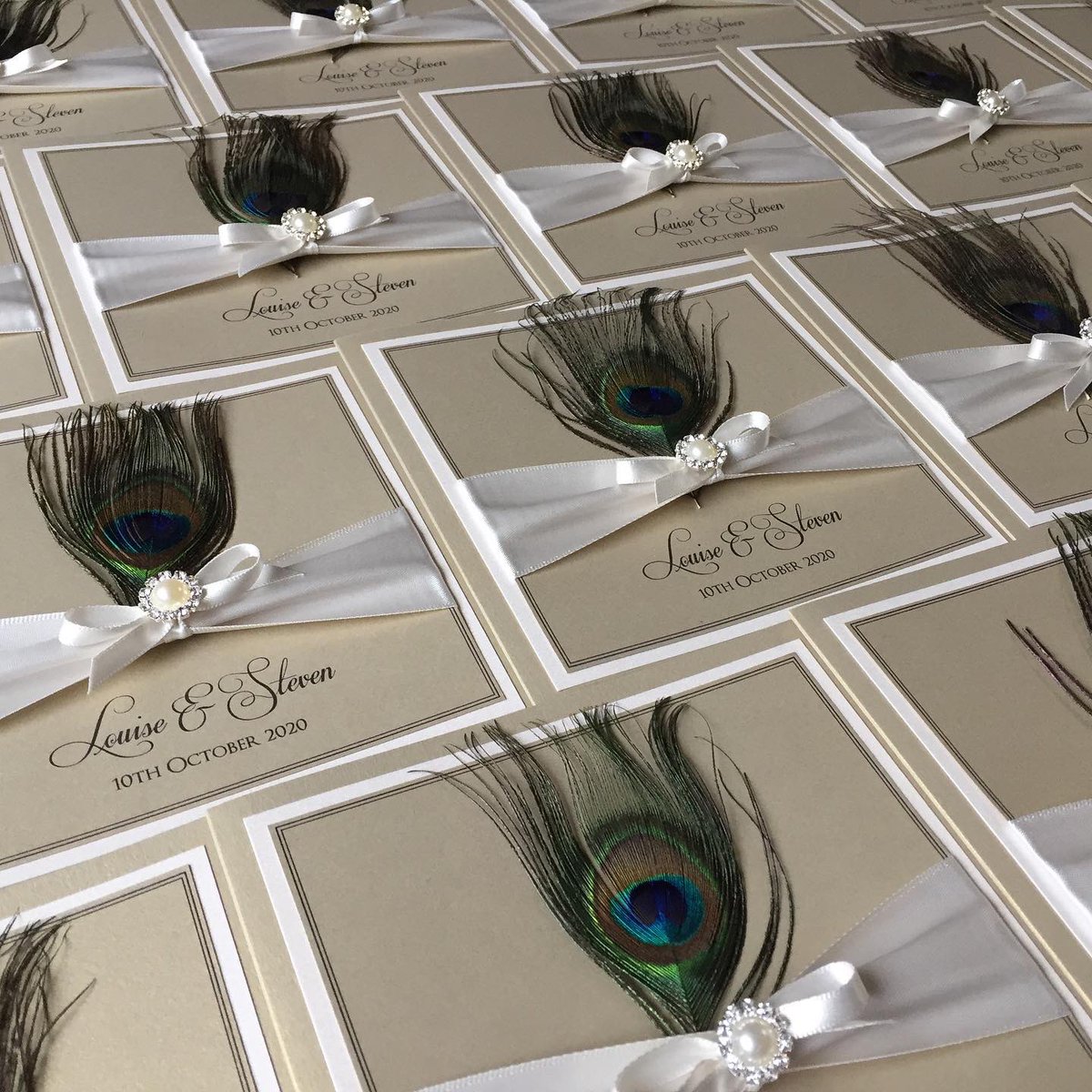 designerinvite's tweet photo. Beautiful peacock feathers on a pale gold pearlescent card finished with ivory bows &amp; Pearl &amp; diamante embellishment 
#wedding #stationery #invites #invitations #peacock #feathers #teal #gold #pearl #diamante #2020wedding #2021wedding #brideandgroom #mrandmrs #custom #engaged https://t.co/IIKwwYdzXL