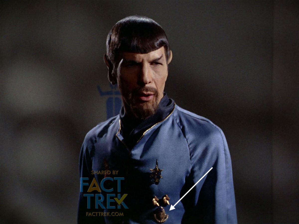 UPDATE! Fact Trek Fellow  @ryantriddle pointed out that the “Outpost” insignia also appears on the mIrror universe uniforms of Spock and Bones, there a different color (gold not white), rotated 90º up or down, and without the black backing. We’ll get you a closeup shortly.