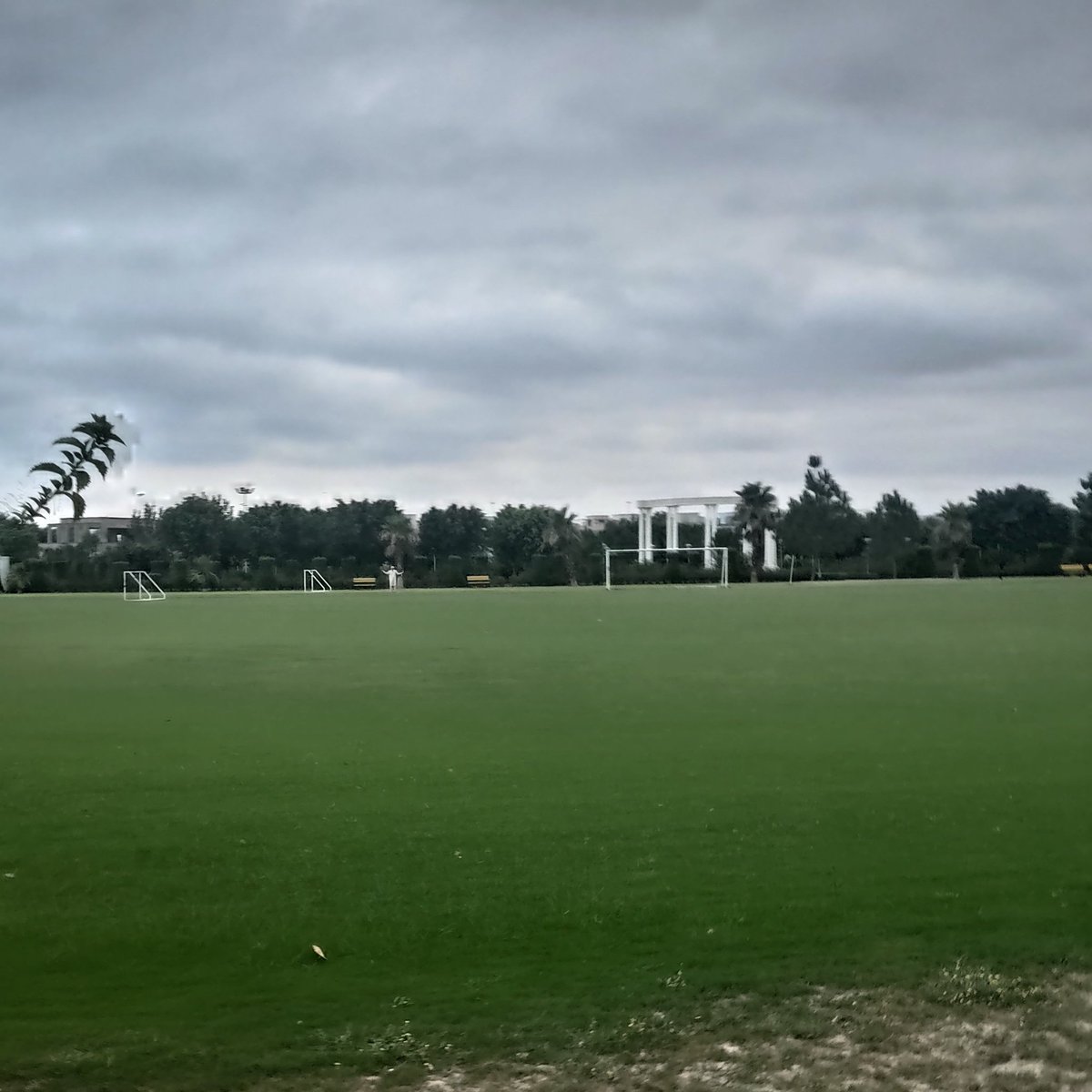 akhter_adil's tweet photo. What I realize is that the journey maybe difficult and hard at times but it is important to take one day at a time and celebrate ones achievements. This picture to me represents adversity (dark clouds)  and success (a white podium amongst lush green grass). https://t.co/EkFHrgvJIp