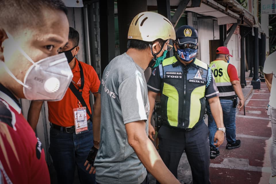 ANCALERTS's tweet photo. Veteran journalist Howie Severino was apprehended by barangay officers and police after pulling down his face mask for a drink. Severino was brought to Amoranto Stadium for a short seminar on proper use of face masks in public. (Photos: Luis Liwanag) https://t.co/9ligP5AhPh