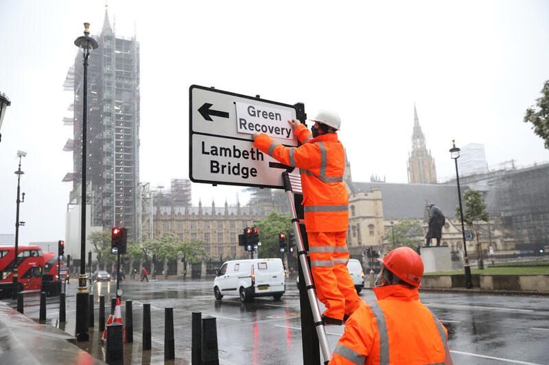 GreenpeaceUK's tweet photo. BREAKING: 
A small team of socially distance activists got creative with roads signs around Westminster this morning.

We're here reminding @RishiSunak that the only recovery is a #GreenRecovery ahead of his big speech today.

#BuildBackBetter https://t.co/6EUikxh32j