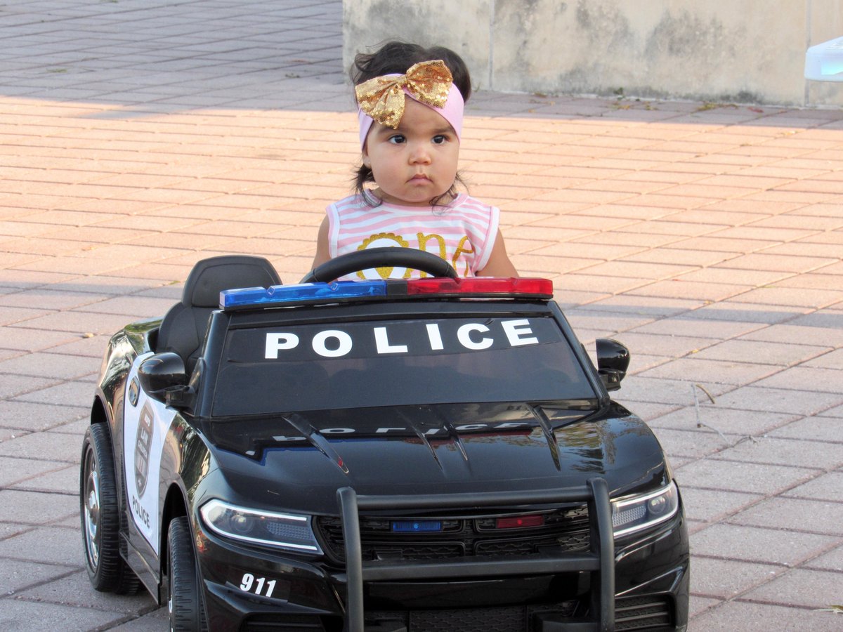 ChiefRobledo's tweet photo. For her first birthday, Penny chose @PfPolice and @Pf_K9s Lubo to celebrate with. She wanted to unveil her new police car and share her cupcakes with her blue family. How could we say no? https://t.co/h7qKY1XZtH