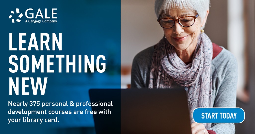 an older woman with short grey hair  sitting down and looking at her laptop with a smile
