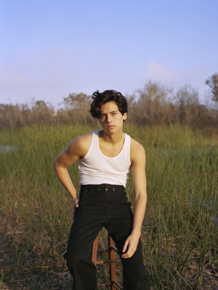 cole sprouse in a white tank top