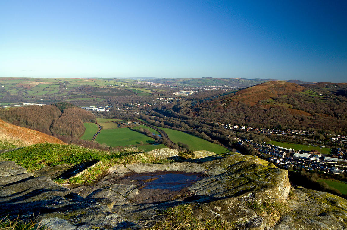 Decades of recent industrial activity has decimated much of Lesser Garth's original cave system.But nothing compares with the aerial view.The verdant wooded slopes seen from the A470, Wales' major north-south carriageway, are merely cosmetic…Because there is little beyond.