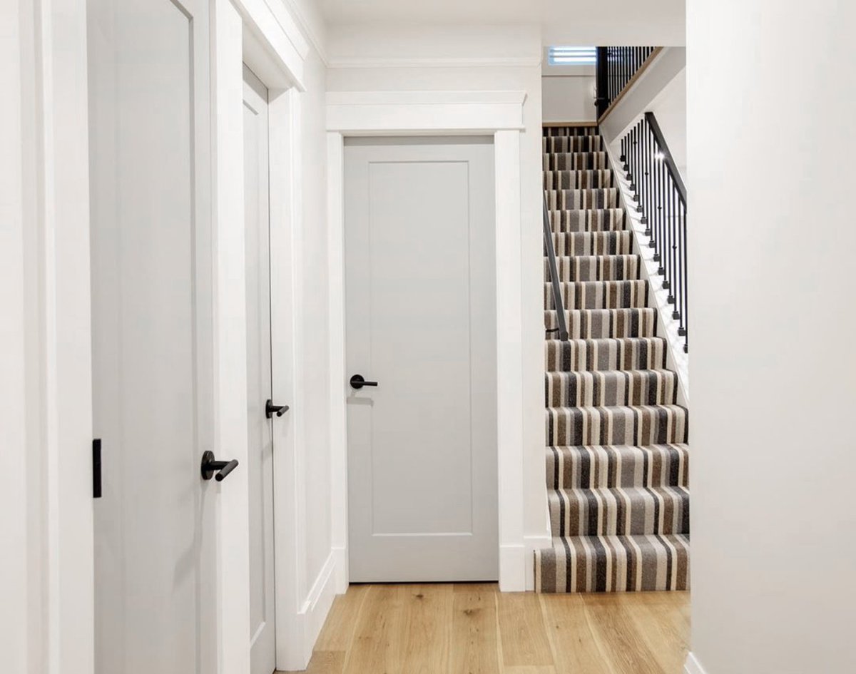 TaymorDesign's tweet photo. Striped carpet dresses up this classic stairway while moulding and trim details create a customized, timeless look by Loft + Maven and Kennedy Construction. Featured Taymor product: Bergen lever in matte black. https://t.co/pVAh8FKkuz