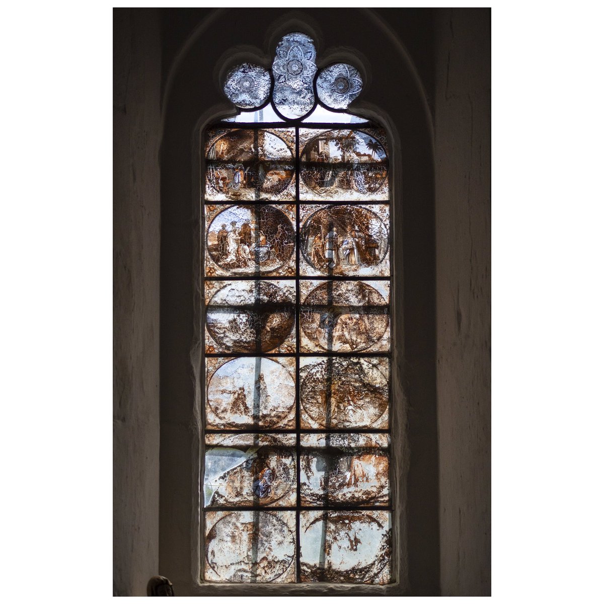 But the most intriguing part of this Hertfordshire church is one of the southeast windows. Twelve roundels depict scenes from the Life of Christ. But this isn’t stained or painted glass. It’s something I have never seen in a church before… glass transfer painting.2/7