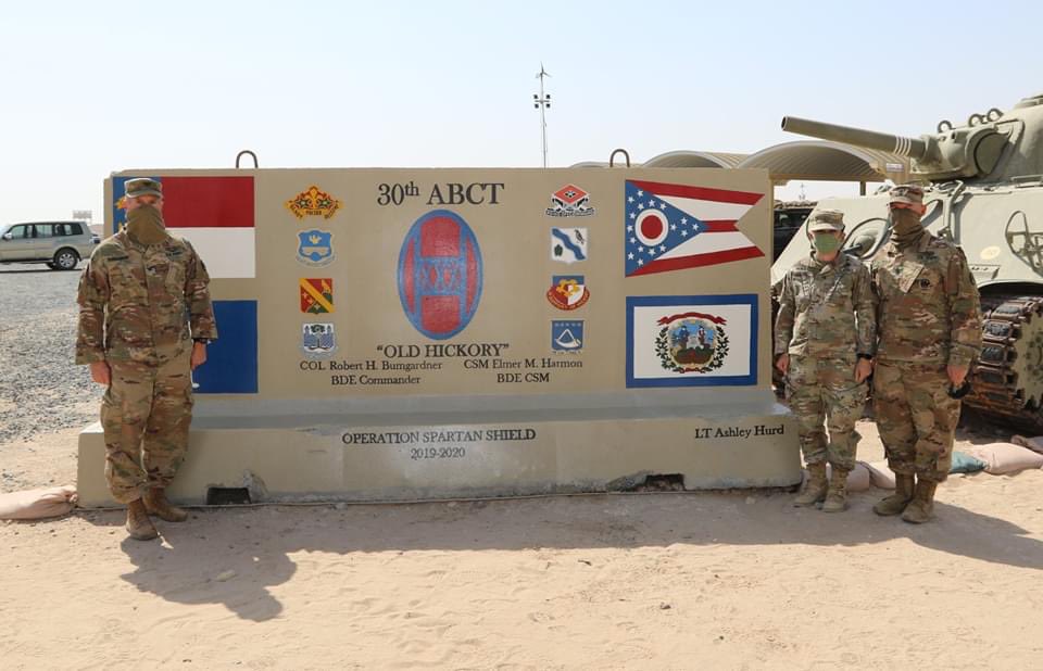 30thabct's tweet photo. U.S. Soldier, 2nd Lt. Ashley Hurd, a tank platoon leader attached to the 1-145 Armor Regiment, #30thabct, paints the second side of the #30thabct T-Wall marking the brigades legacy while deployed in the @CENTCOM area of responsibility for @TFSpartan, July 8, 2020. https://t.co/fUBfAX2zpV