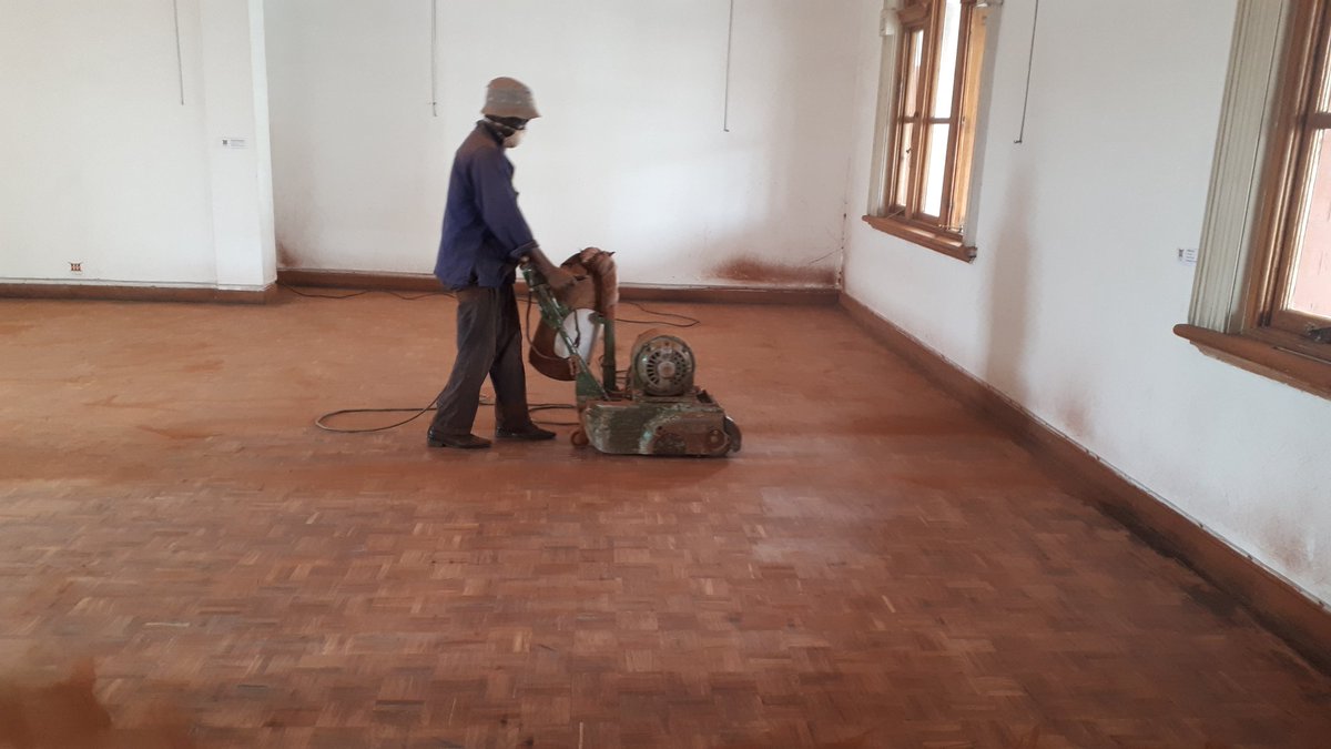kgosinyathi's tweet photo. Sanding the tiled floor and installing a solar system. New roof, ceiling, air conditioners, lighting system, disability ramp and new paint work. Still on lockdown but hard at work. Story of @BYOgallery. https://t.co/AKrQQnU6f2