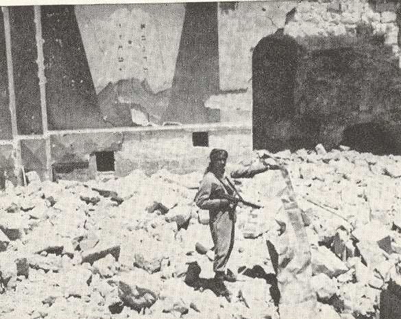 Hurva became Jerusalem's main Ashkenazic synagogue, until it too was destroyed by the Arab Legion during the fighting in the 1948 Arab–Israeli War.Pictured: Arab Legion soldier posing in the ruins of the Hurva Synagogue, Jerusalem.