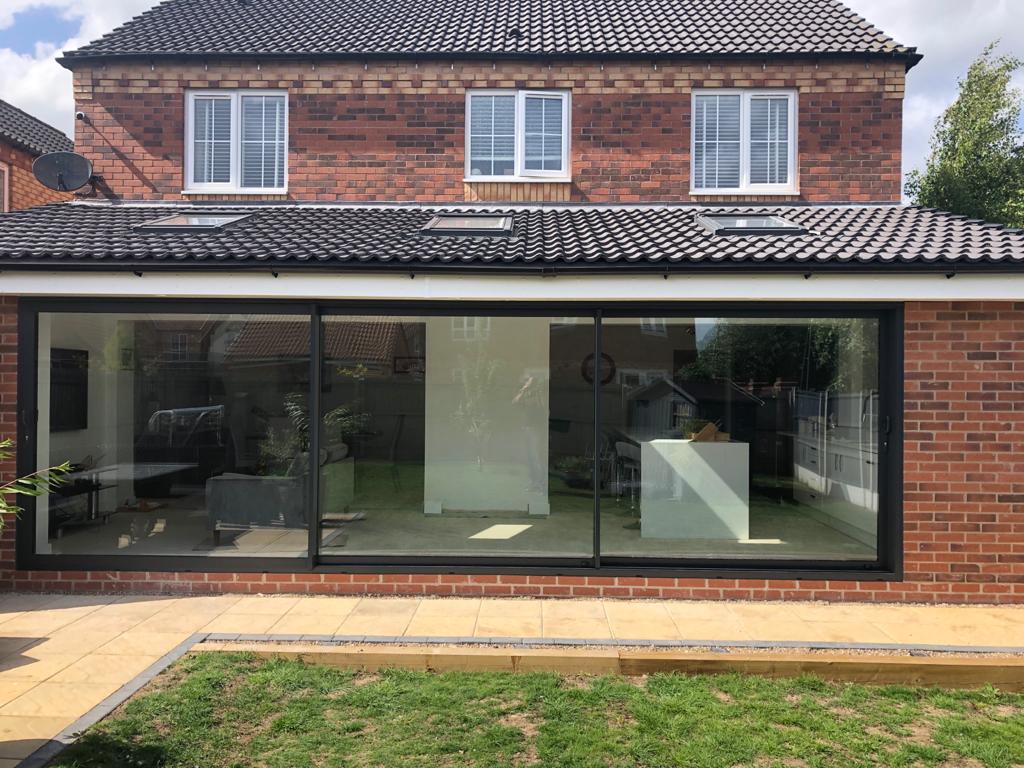 Anthracite grey aluminium triple track sliding patio door installed in Long Eaton. For a free quotation call us on 01158 660066, visit thenottinghamwindowcompany.co.uk or pop into our West Bridgford showroom. #Nottingham #aluminium
